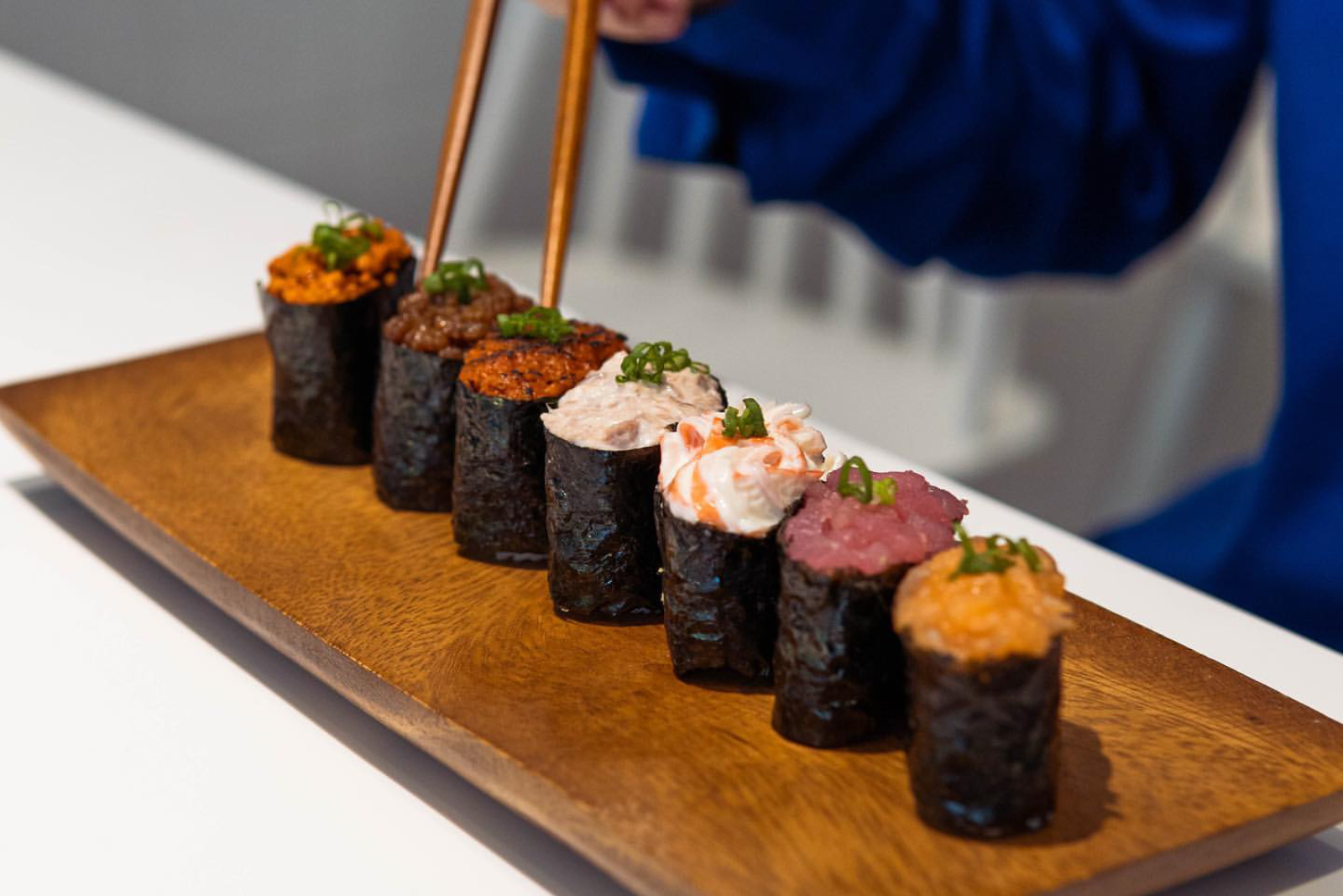 Japanese chefs preparing fresh sushi at Daily Sushi ITPL